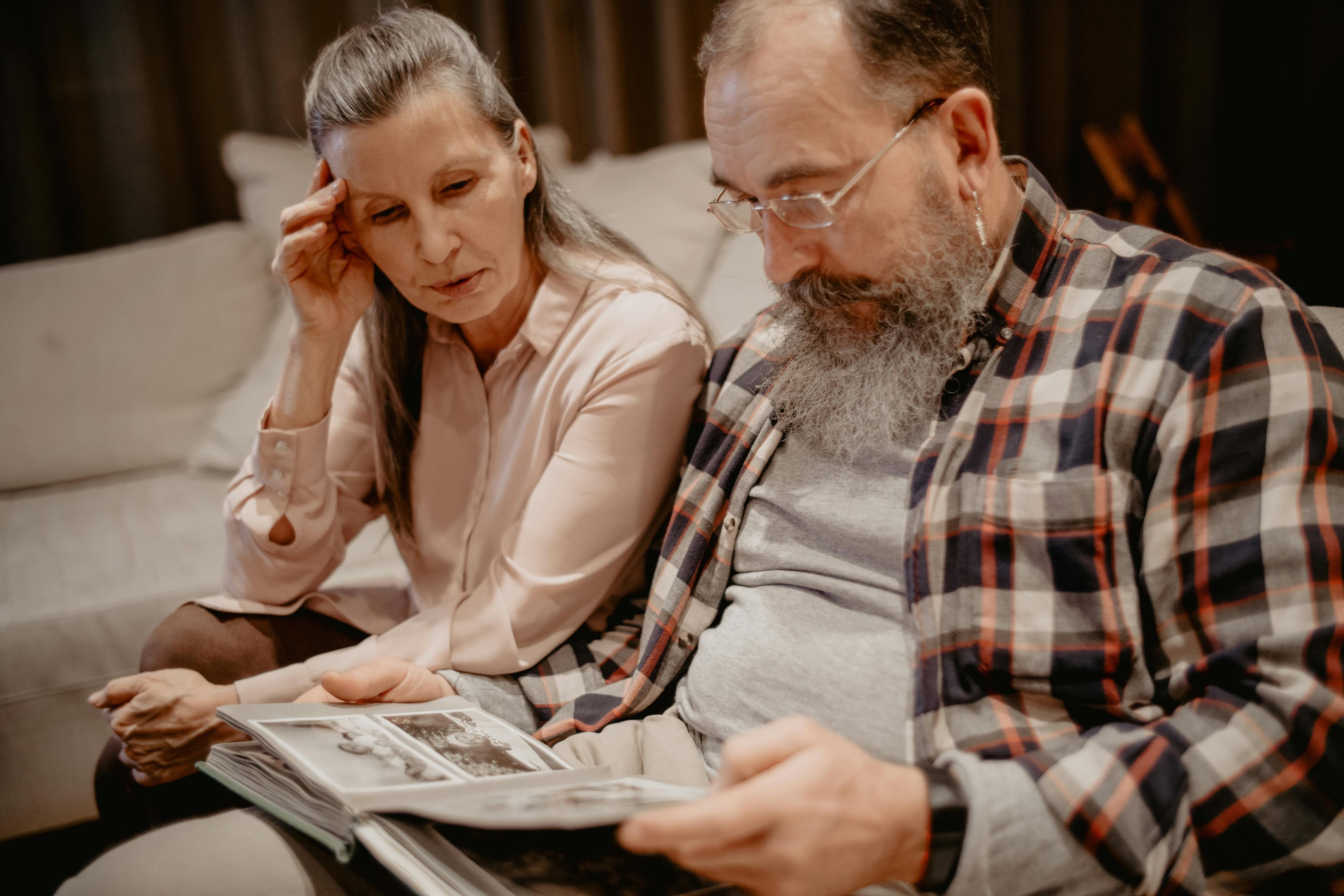 An older couple looking through a family photo album
